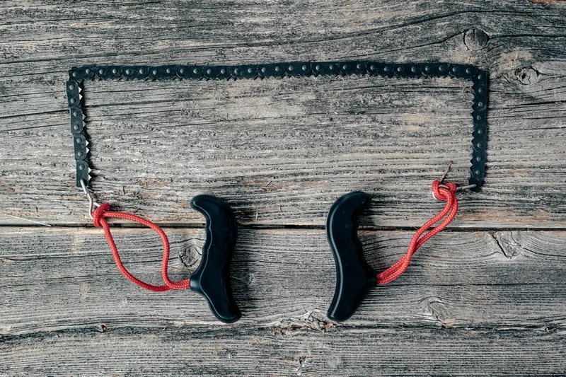 Compact Camping Pocket Chainsaw On Outdoor Flatlay 1